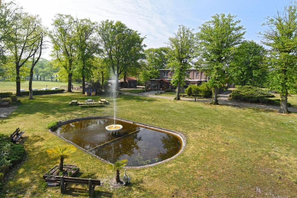 a fountain in the middle of a park at Stichting InnEssence Stokershorst in Nederweert-Eind
