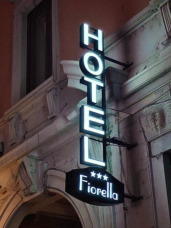 a neon sign on the side of a building at Hotel Fiorella Milano in Milan