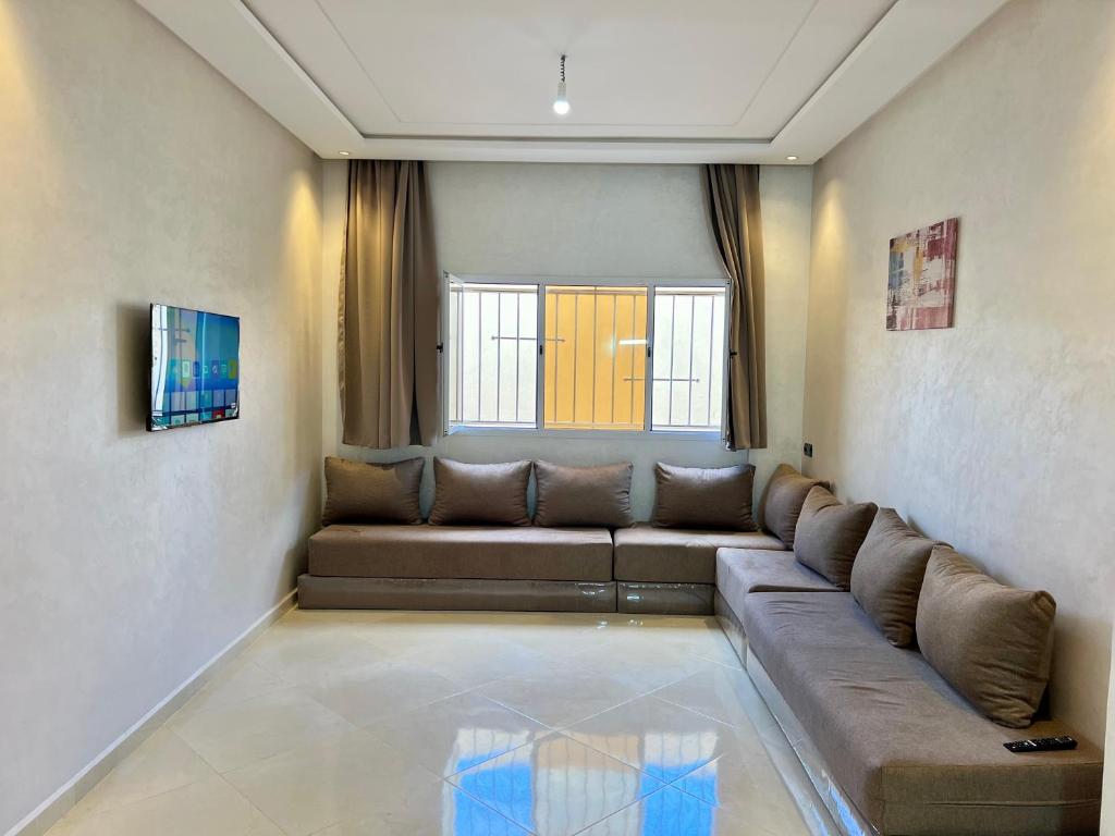 a living room with a couch and a window at sahara house in Laayoune