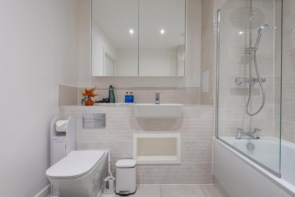 a bathroom with a toilet and a sink and a shower at The Oasis in Stonewood