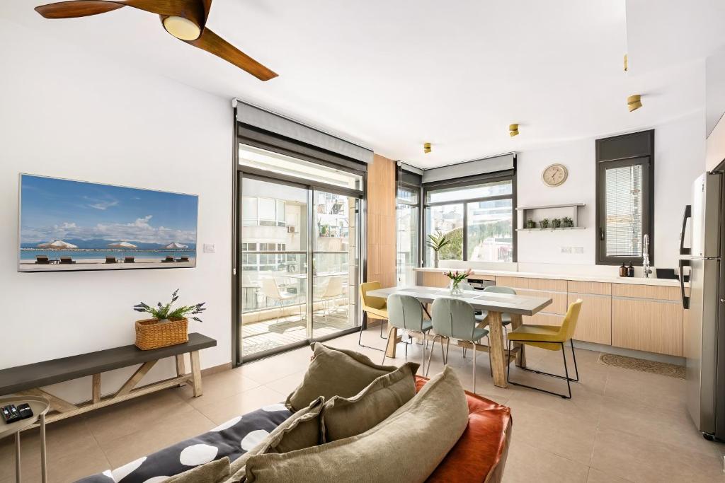 a living room with a couch and a table at Luxury Beachside 3BR with Balcony in Tel Aviv