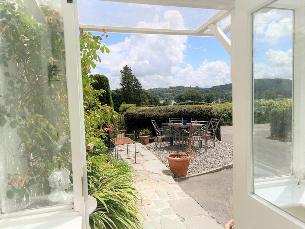 a view from a window of a patio with a table and chairs at 3 Bed in Ambleside oc-62587 in Far Sawrey