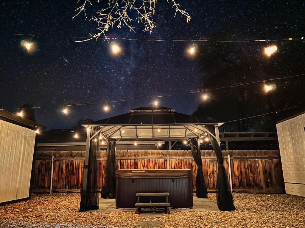 a stage with a bench under a starry sky at Sun & Snow Bungalow Remodeled Hot Tub W&D in South Salt Lake