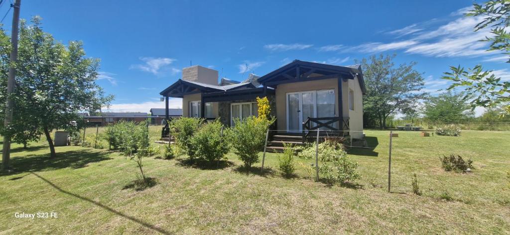 a tiny house in the middle of a field at Loma Alta Apart in Villa Yacanto
