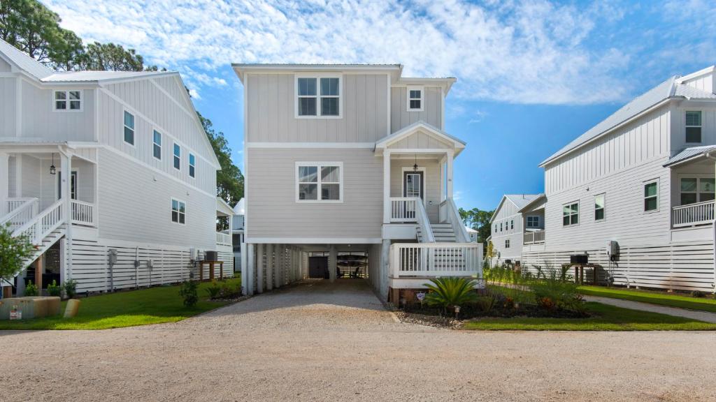 a home with two white houses and a driveway at Harmony by the Bay in Santa Rosa Beach
