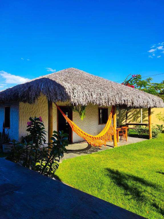 a hut with a hammock in front of it at suite elegante fullhausi 02 in Fortim