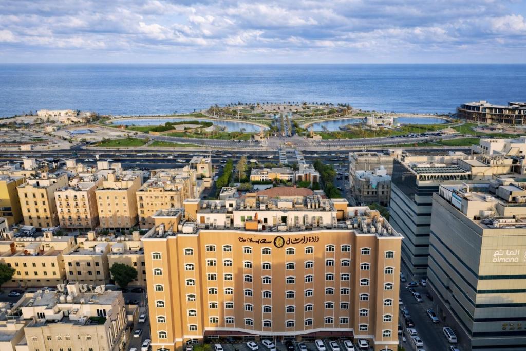 an aerial view of a city with the ocean at Sand Rose Hotel Apartments in Al Khobar