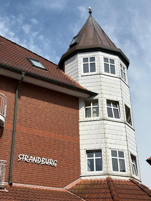 a building with a clock tower on top of it at Turmwohnung 205 in Juist