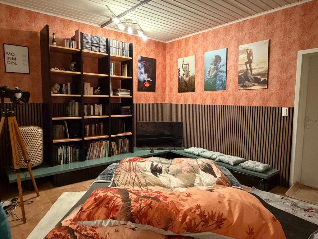 a room with a bed and a book shelf at Momo Den in Blomberg