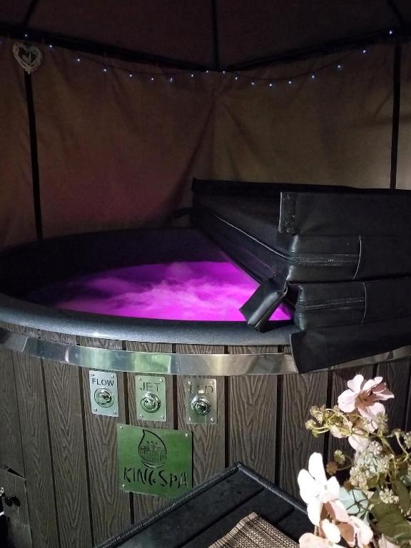 a hot tub in a tent with pink lighting at Arany Virág Vendégház in Mór