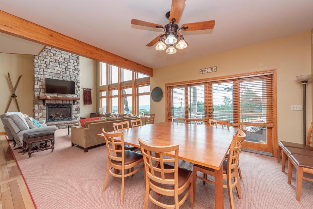 a dining room with a table and chairs and a fireplace at Boulder Creek Lodge by Railey Vacations in McHenry