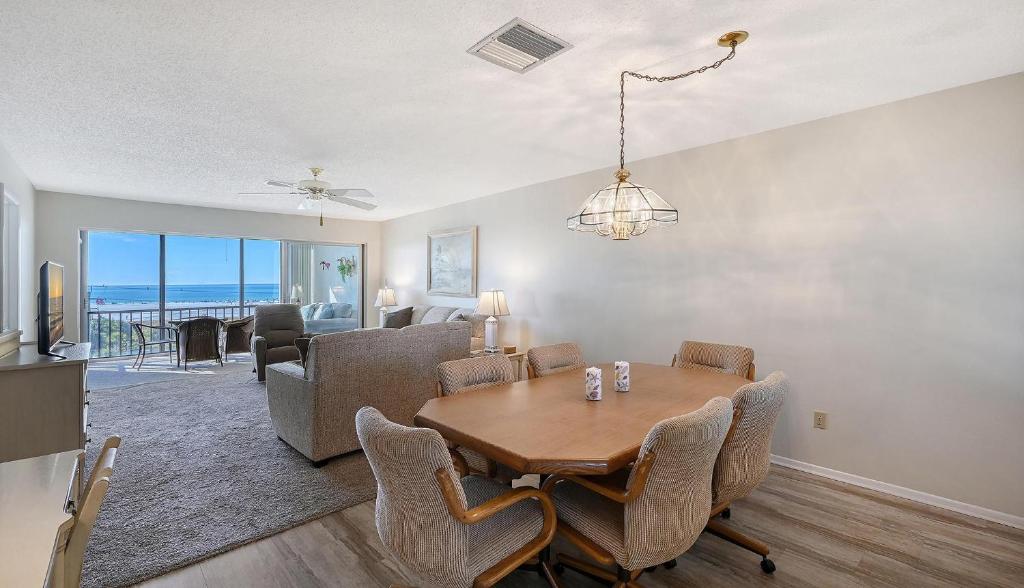 a dining room and living room with a table and chairs at Crescent Royale Condominiums 515 in Siesta Key