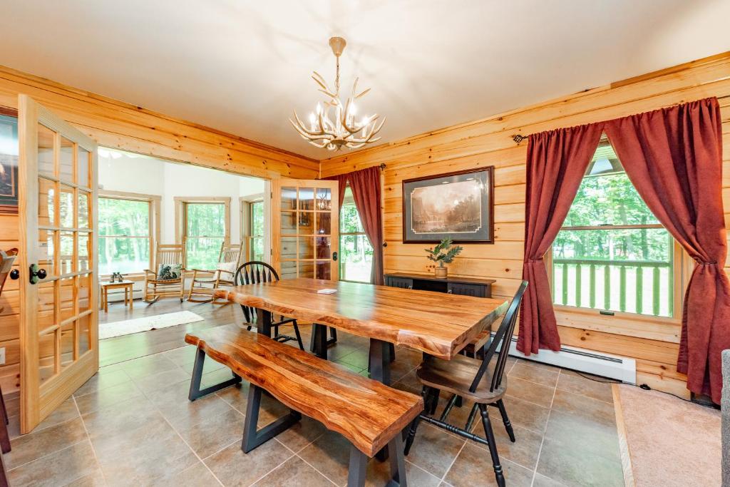 a dining room with a wooden table and benches at Bucks Run by Railey Vacations in Oakland