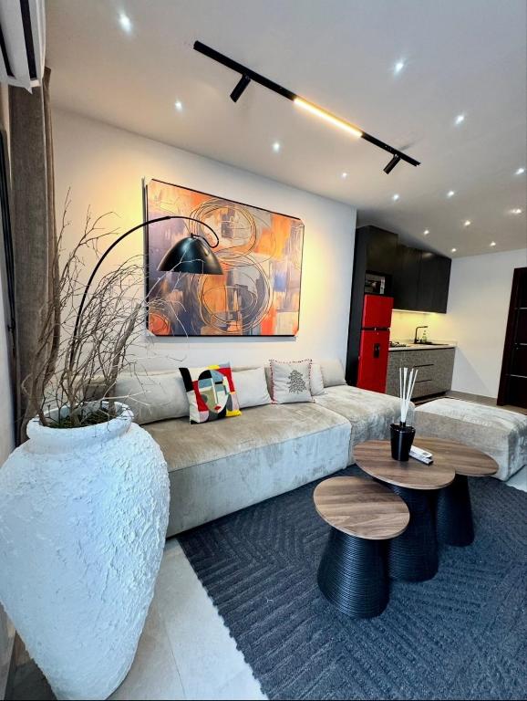 a living room with a couch and a table at MAISON 9 Apartments Surulere in Lagos