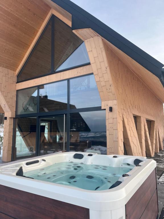 a hot tub on the deck of a house at 3 Sówki in Krajno Zagórze Drugie