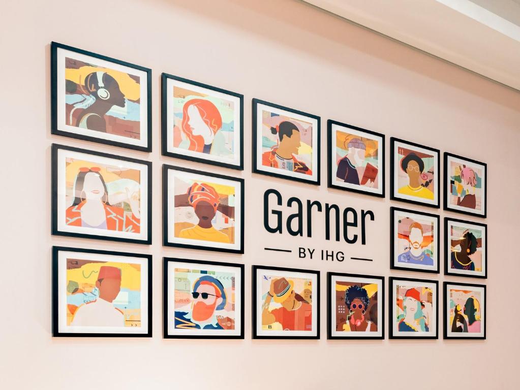 a group of framed pictures on a wall at Garner Hotel Stuhr - Bremen A1 by IHG in Bremen