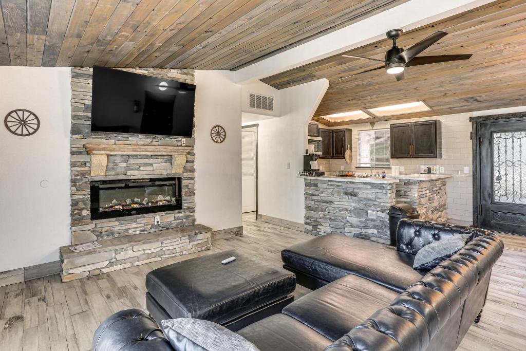 a living room with a couch and a fireplace at 1 Mi to Main St Eats! Single-Level Red Bluff Home in Red Bluff