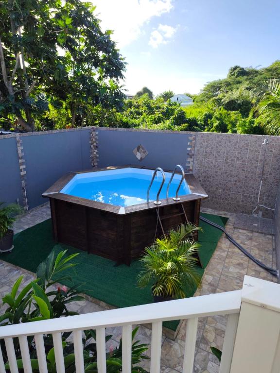 a hot tub on the patio of a house at Haut de villa " JODI " in Sainte-Rose