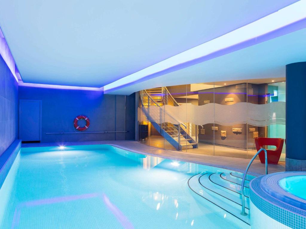 a swimming pool with a slide in a hotel at Novotel Edinburgh Centre in Edinburgh