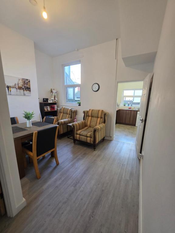 a living room with two chairs and a table and a room with a tablektop at Magic Stays! in Halton