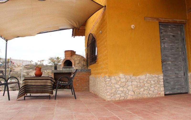 a patio with a table and chairs on a building at Eco ITZKA Bernal Country House in Bernal