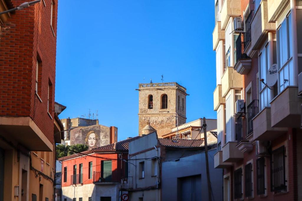 a view of a city with a clock tower at Reina Amalia in Quintanar de la Orden