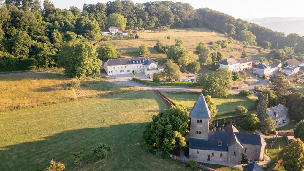 an aerial view of a house on a grassy hill at Hazelnut House - Luxembourg's Secret Small Hotel in Girsterklaus
