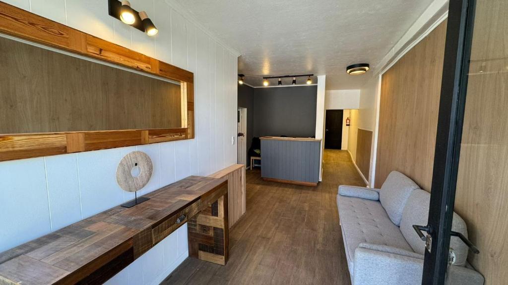 a room with a bench and a mirror on the wall at Hotel Manquehue in Esquel
