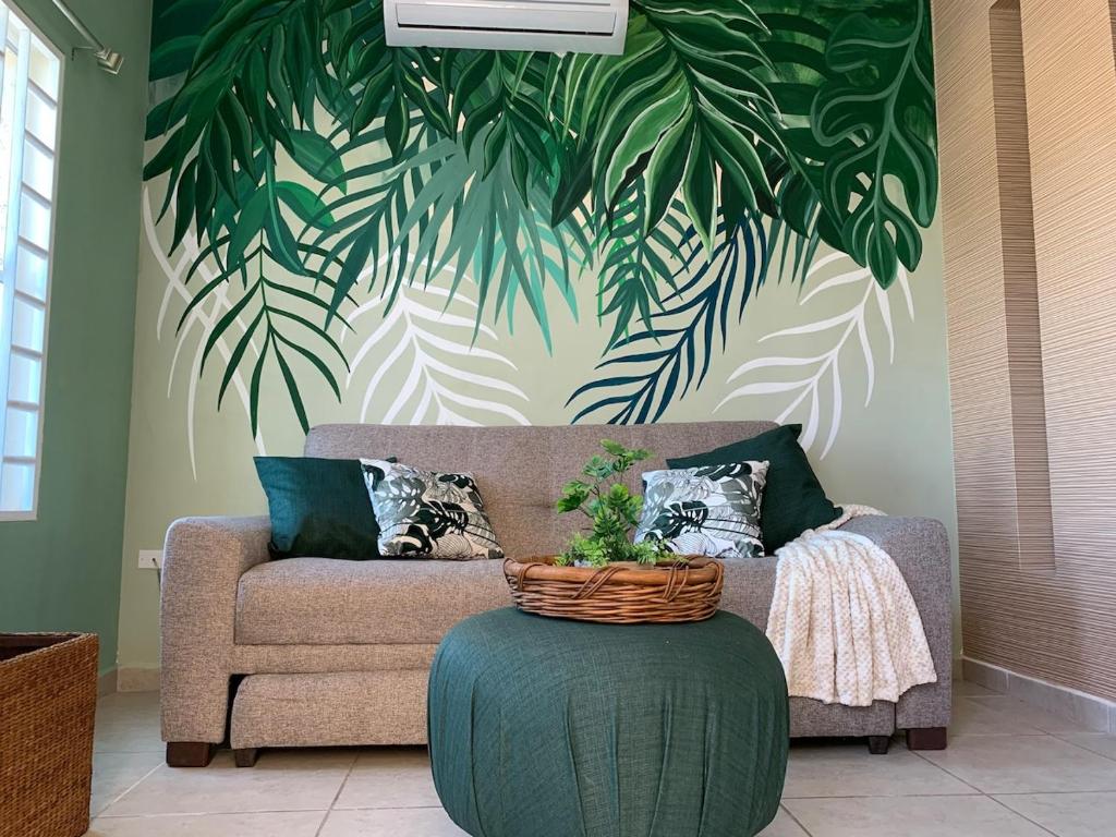 a living room with a couch and a table with a plant at Casa Familiar en La Paz BCS in La Paz