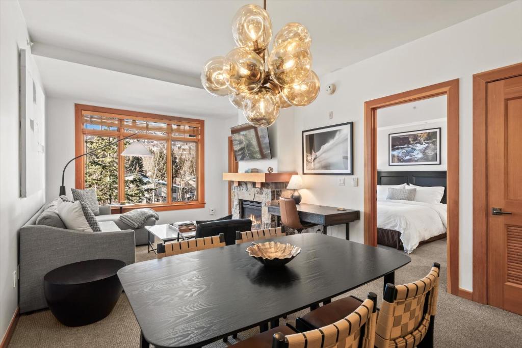a living room with a table and a bedroom at The Powder Post Capitol Peak Lodge #3225 in Snowmass Village