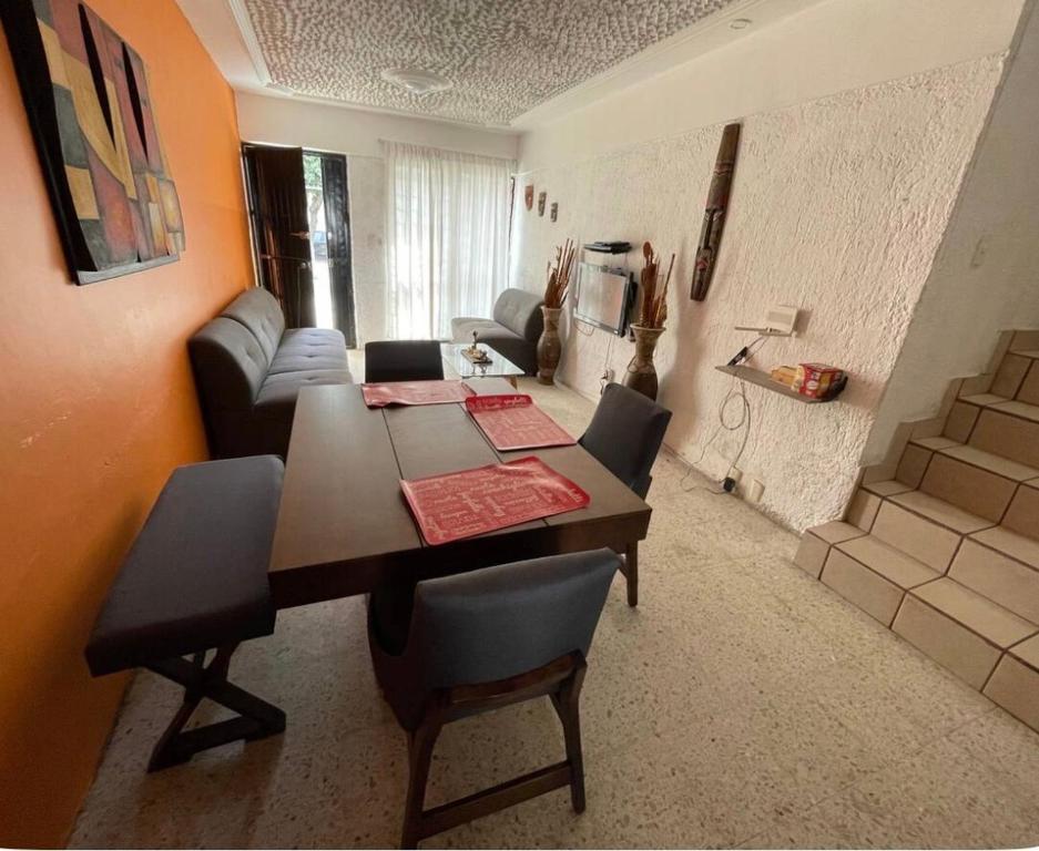 a living room with a dining room table and chairs at Casa del Estadio in Guadalajara