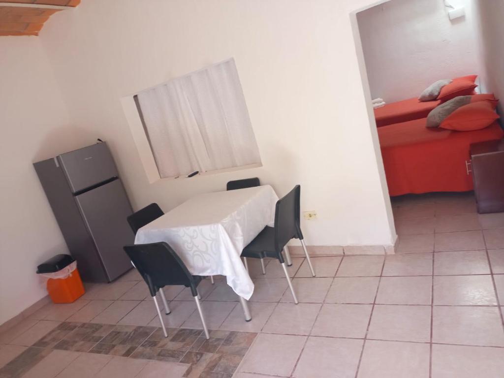 a room with a table and chairs and a bed at Casa Amelia in San Blas