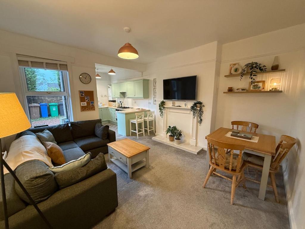 a living room with a couch and a table at Flat in Lundin Links in Lundin Links