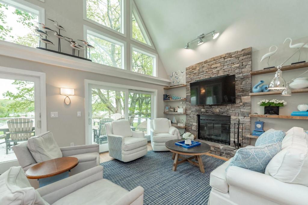 a living room with white furniture and a fireplace at Starry Night by Railey Vacations in Swanton