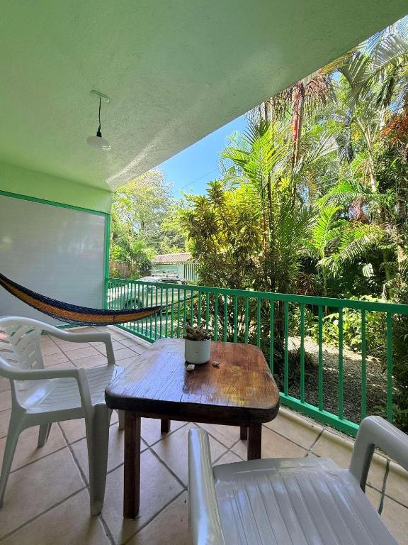 a balcony with a table and chairs and a screen at Bohemian Monkey in Cahuita