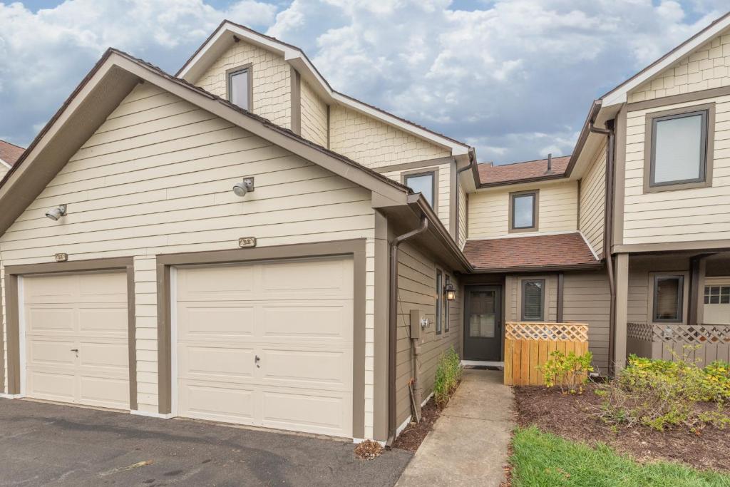 a house with two garage doors in a driveway at Ski Harbor #32 by Railey Vacations in McHenry