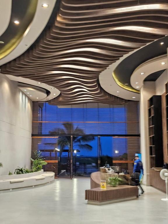 a lobby with aavy ceiling in a building at GabyMar salinas del mar Santamarta in Santa Marta