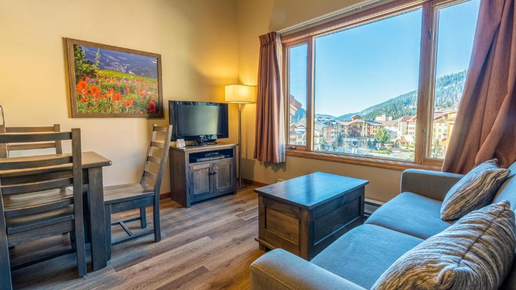 a living room with a couch and a tv at Cahilty #454 home in Sun Peaks