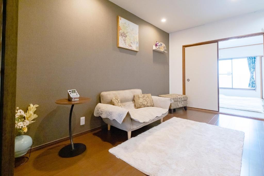 a living room with a chair and a table at 逸泊居 in Osaka