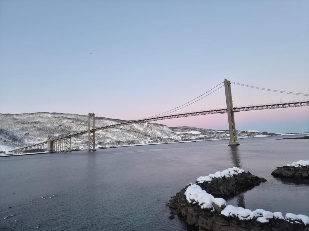 a bridge over a river with snow on it at Tjeldsund Tide nr. 6 in Steinsland