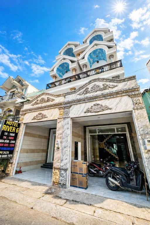 a building with a motorcycle parked in front of it at River 6 Hotel in Long Xuyên