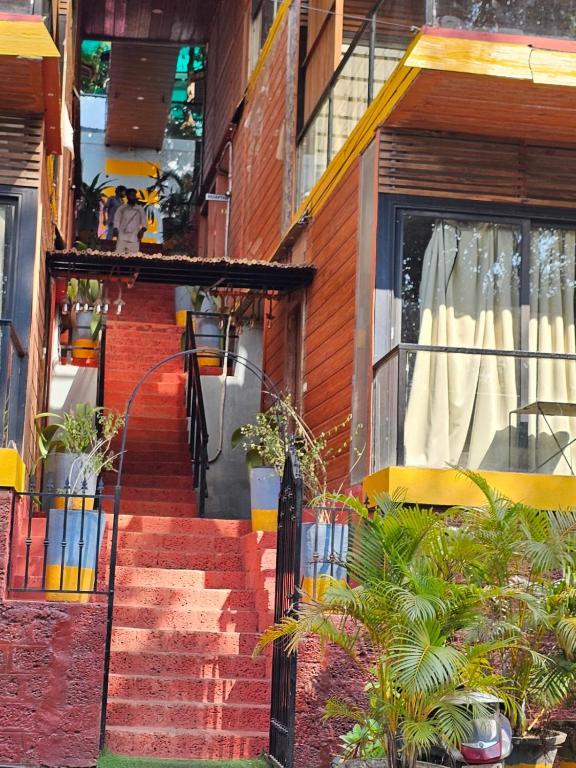 a staircase leading up to a building with a window at Hillora Coastal Resort in Arpora