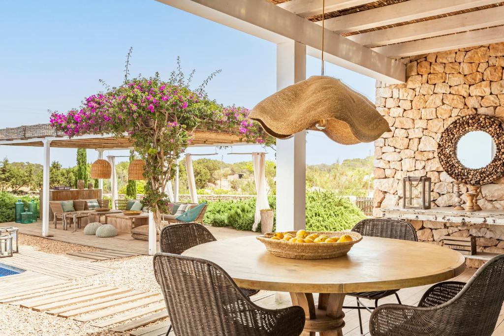 a table with a bowl of fruit on a patio at Villa Charming House in La Mola
