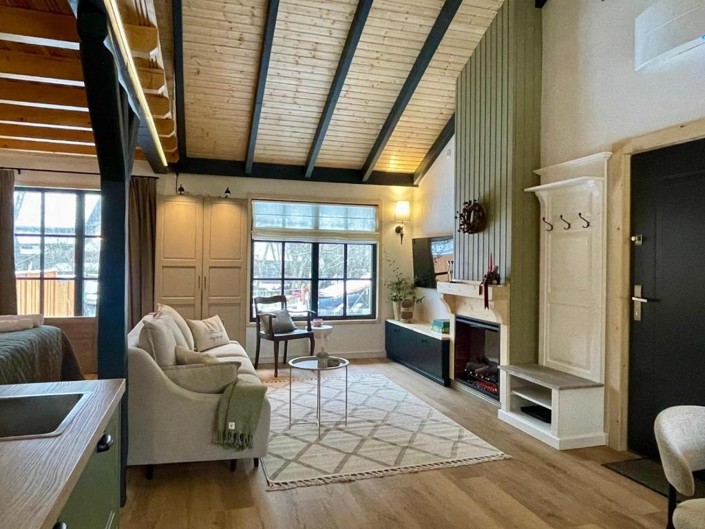 a living room with a couch and a table at Country Charm in Râşnov