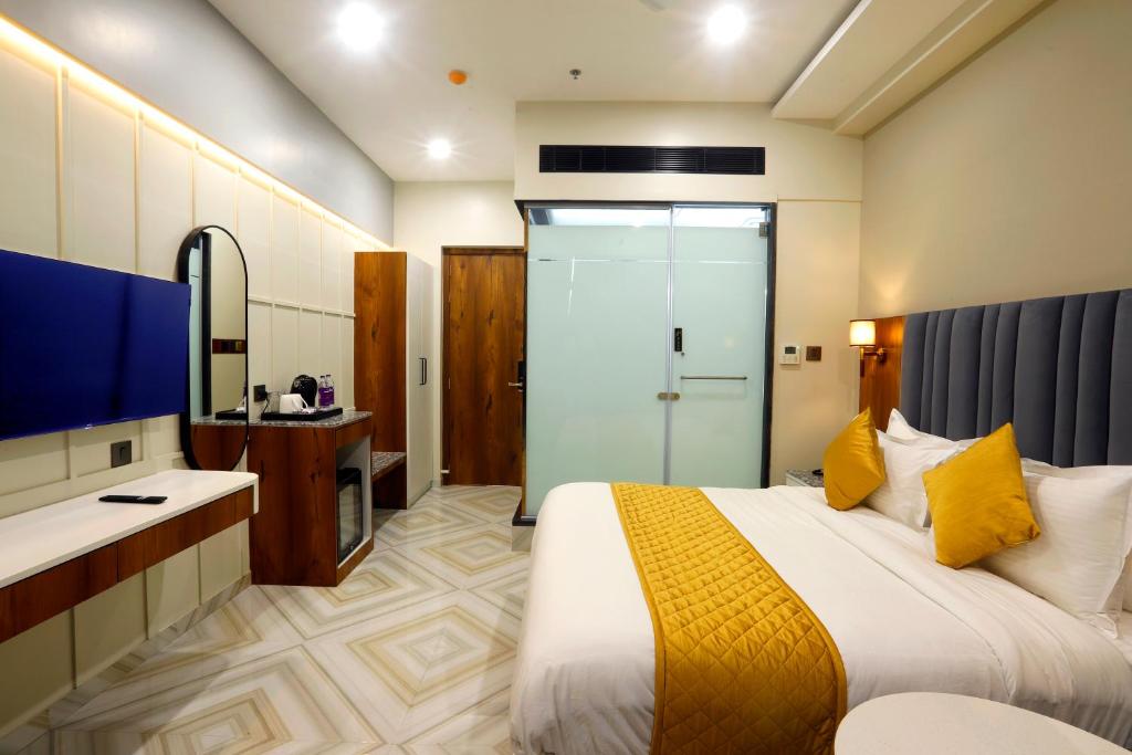 a hotel room with a bed and a bathroom at HOTEL BREEZE BAY EX - NEAR US Consulate, BKC in Mumbai