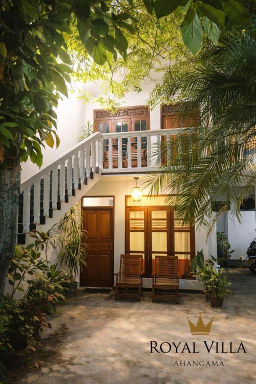 a building with two chairs in front of it at Royal Villa in Ahangama