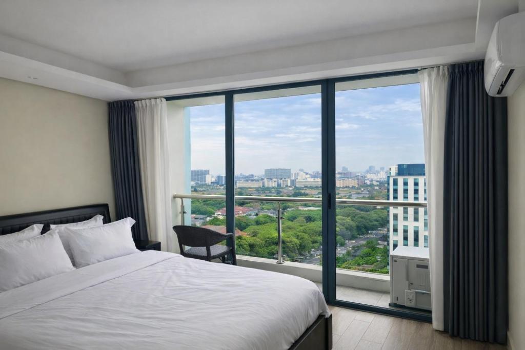 a bedroom with a bed and a large window at LCONDOTEL Imperial Plaza Residences in Manila