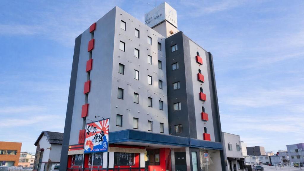 a tall white building with red windows at Palude Kushiro in Kushiro