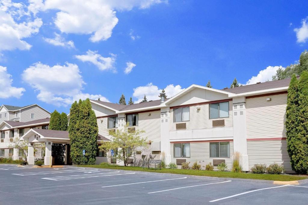 a large white building with a parking lot at Super 8 by Wyndham Cloquet in Cloquet