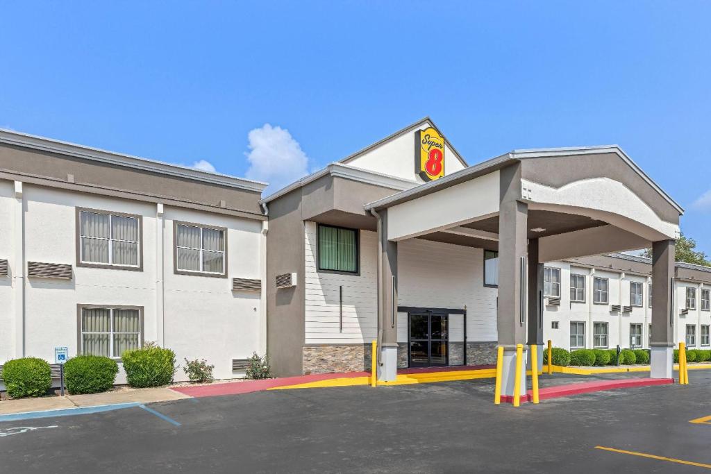 a hotel front of a building with a parking lot at Super 8 by Wyndham Athens in Athens
